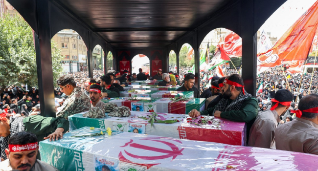 In-this-picture-obtained-from-Irans-ISNA-news-agency-mourners-stand-next-to-the-bodies-of-people-k